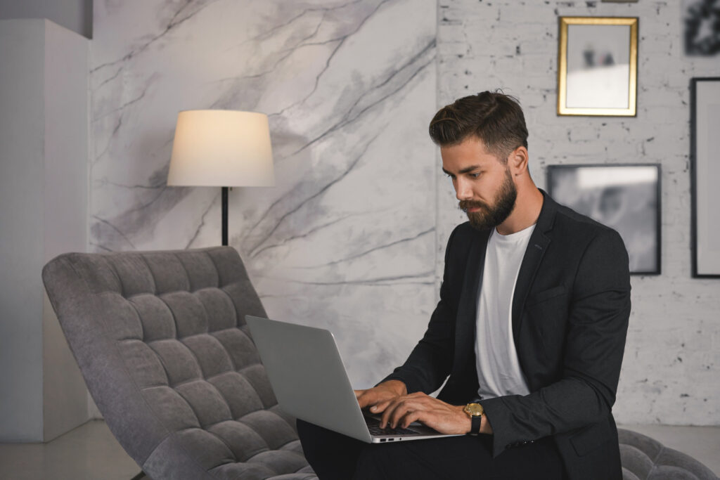 business man in front of the computer looking for MTD for Income Tax information 