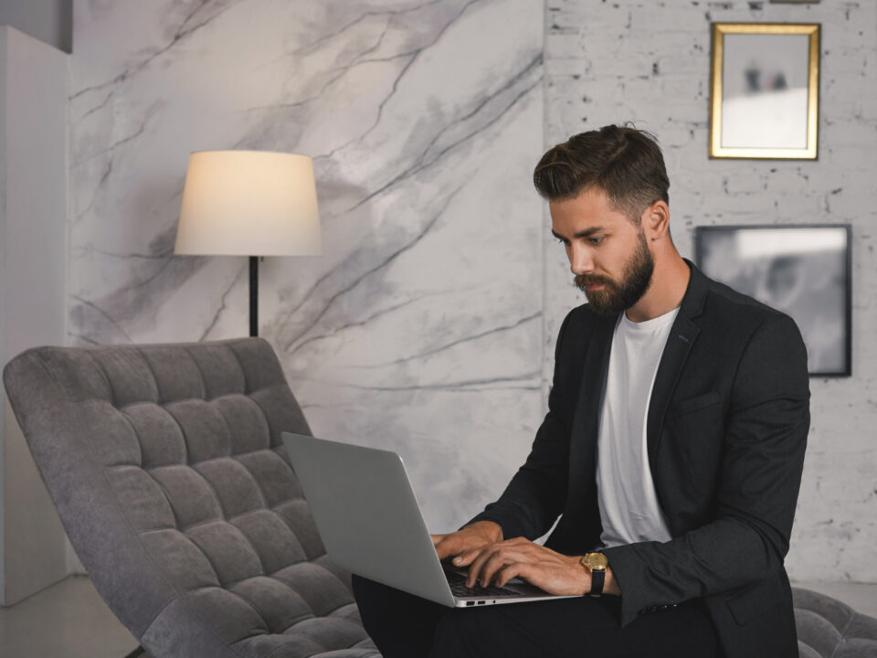 business man in front of the pc looking for more info about MTD for Income Tax