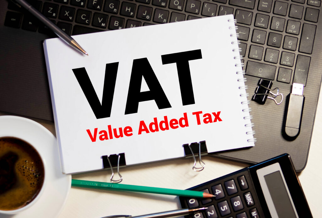 Small business owner reviewing VAT Flat Rate Scheme advantages on a laptop